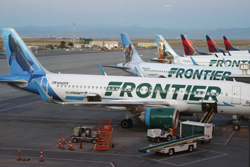FILE - Frontier Airlines jets sit at gates at Denver International Airport on Sept. 22, 2019, in Denver. Shares of Frontier Airlines and Spirit Airlines tumbled Monday, June 27, 2022, after their improved merger proposal won a key endorsement just days ahead of a crucial shareholder vote. (AP Photo/David Zalubowski, File)