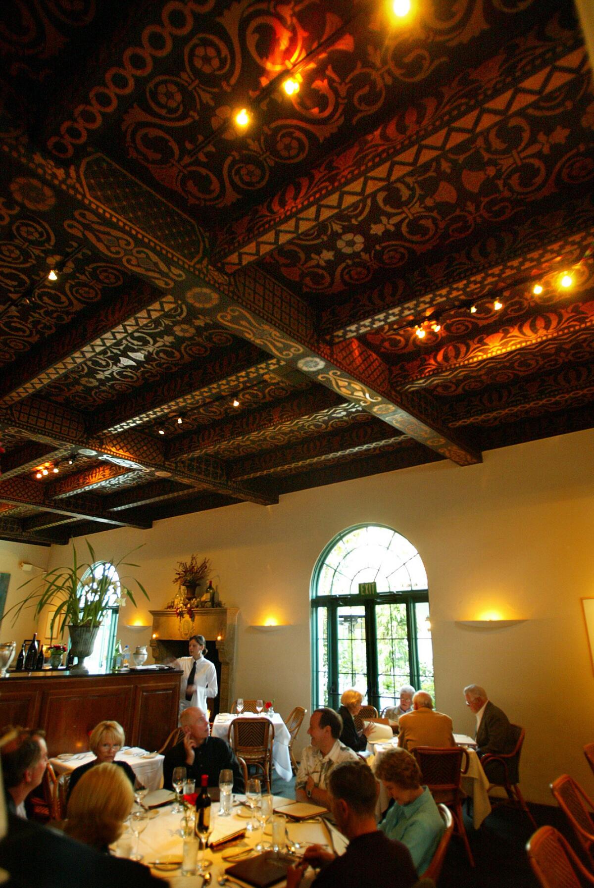 Inside Santa Barbara's historic El Paseo courtyard, the Wine Cask restaurant, as seen in 2004, with hand-painted wood beams.
