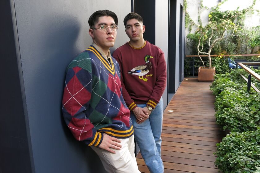Mexican singer-songwriter Kevin Kaarl, left, poses for a portrait with his twin brother and musician Bryan during an interview in Mexico City, Dec. 1, 2022. (AP Photo/Berenice Bautista)