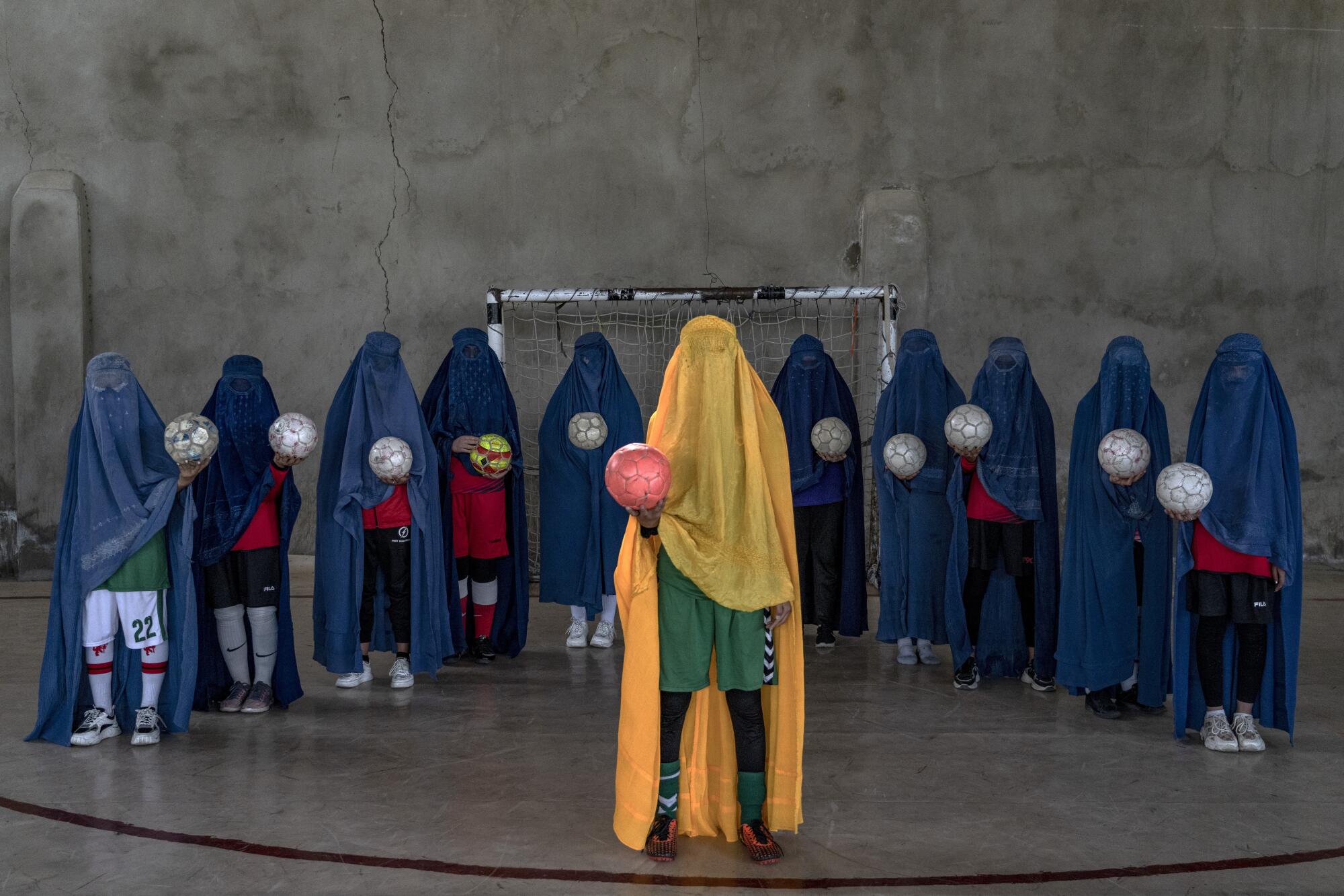 An Afghan women's soccer team poses in burqas.