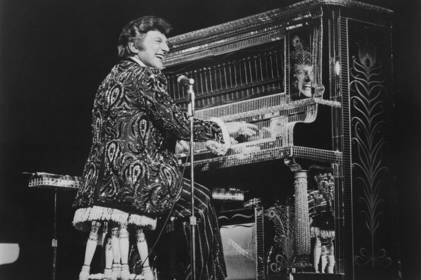 "Mr. Showmanship" takes to the keys of his upright honky tonk piano during a 1983 show at the MGM Grand in Las Vegas.