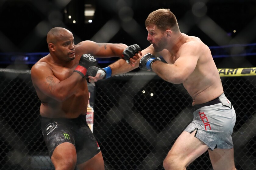 Daniel Cormier and Stipe Miocic throw blows in the first round of their UFC heavyweight title fight at UFC 241 at Honda Center on Saturday.