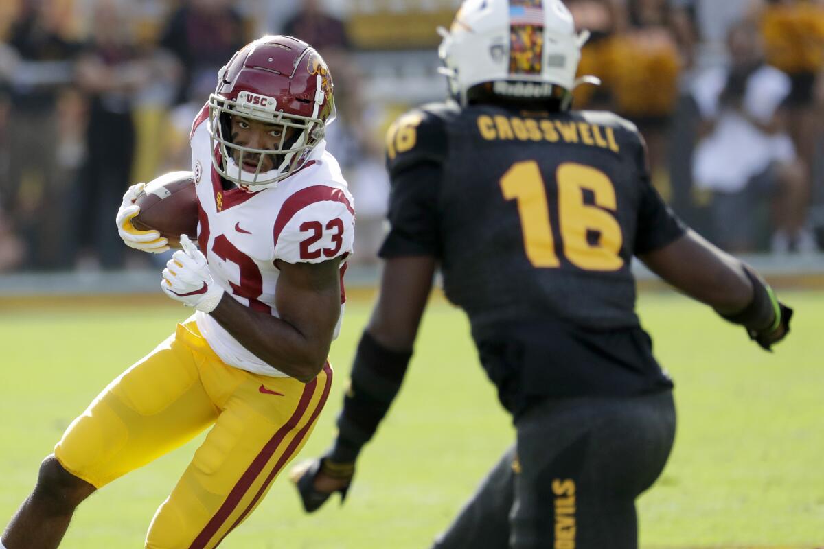 USC running back Kenan Christon carries the ball in front of Arizona State safety Aashari Crosswell.