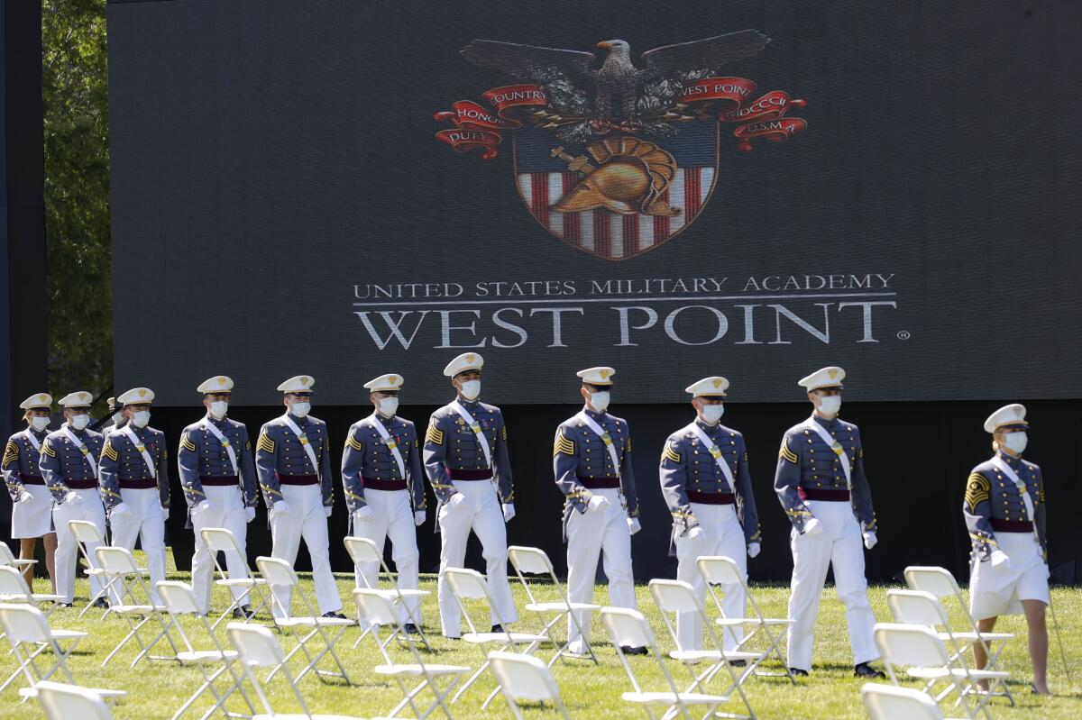 FILE - In this June 13, 2020, file photo, United States Military Academy graduating cadets, wearing face masks, march to their socially-distanced seating during commencement ceremonies in West Point, N.Y. Most of the 73 West Point cadets accused in the biggest cheating scandal in decades at the U.S. Military Academy are being required to repeat a year, and eight were expelled, academy officials said Friday, April 16, 2021. (AP Photo/John Minchillo, Pool, File) (AP Photo/John Minchillo, Pool, File)
