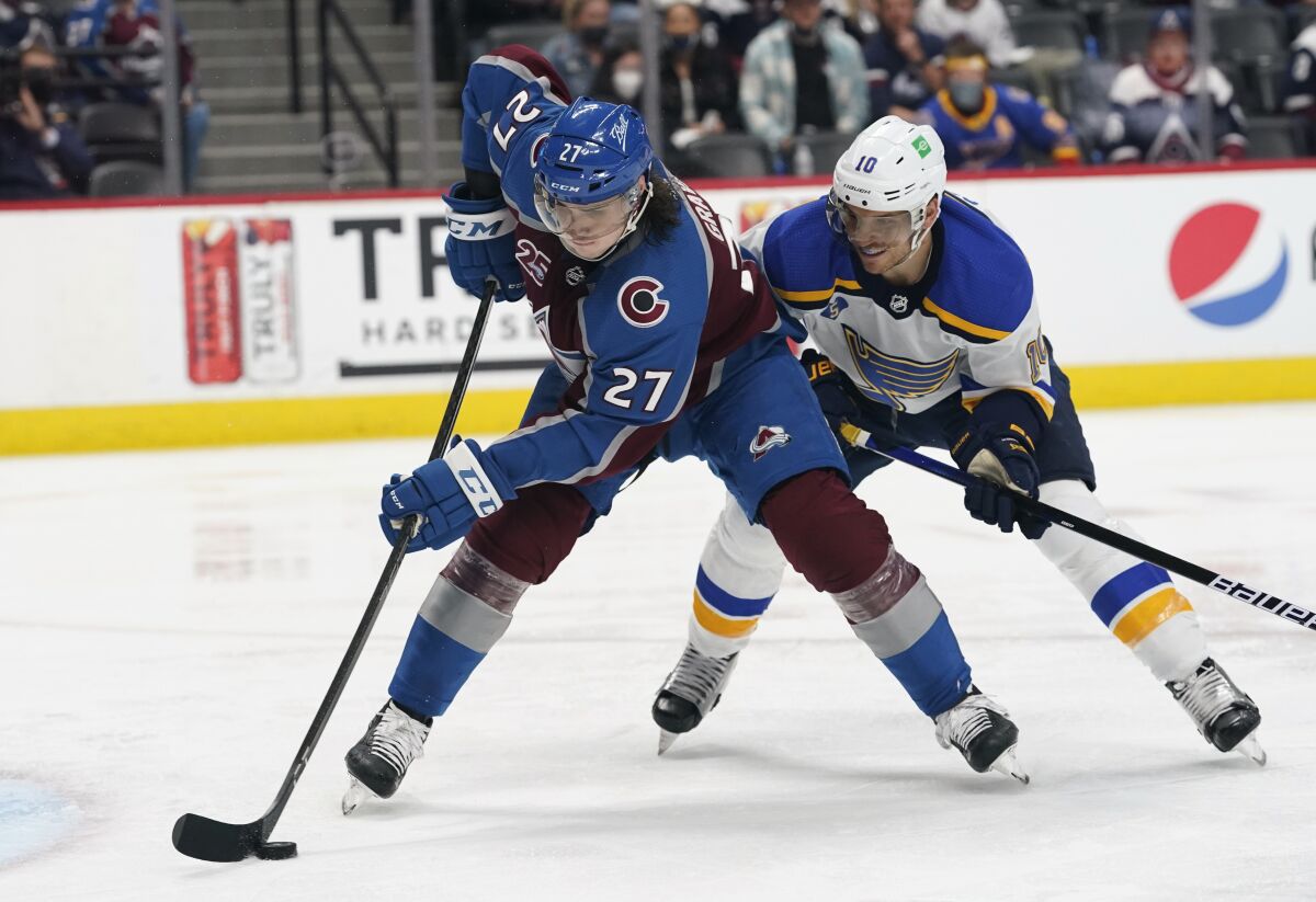 FILE - In this May 19, 2021, file photo, Colorado Avalanche defenseman Ryan Graves (27) works with the puck in front of St. Louis Blues center Brayden Schenn (10) during Game 2 of an NHL hockey Stanley Cup first-round playoff series in Denver. The Avalanche sent Graves to the New Jersey Devils in a move made with an eye on the upcoming expansion draft of the Seattle Kraken. In exchange, the Avalanche acquired forward Mikhail Maltsev and a second-round selection in the 2021 draft from New Jersey. (AP Photo/David Zalubowski, File)