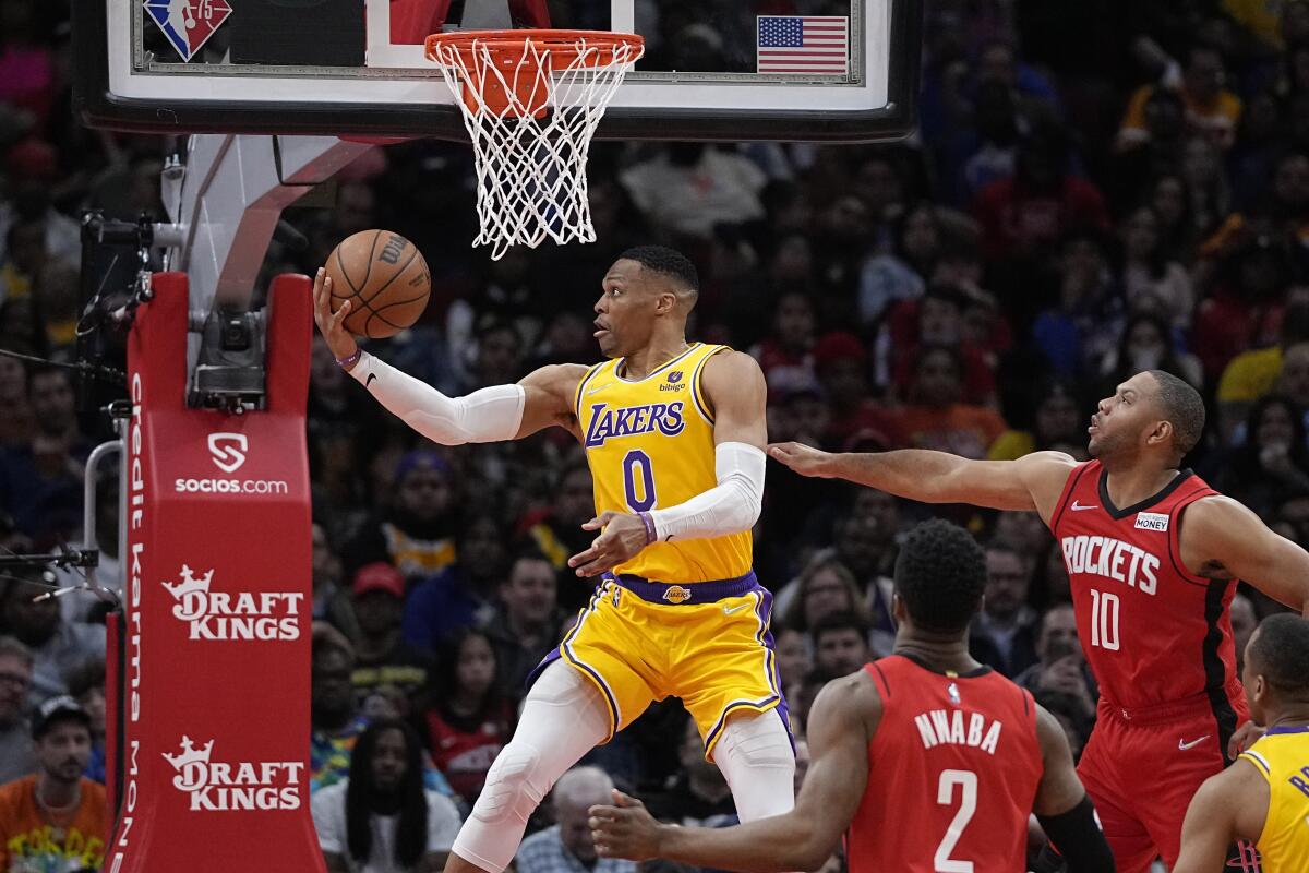 Lakers guard Russell Westbrook elevates for a reverse layup past Rockets guard Eric Gordon.