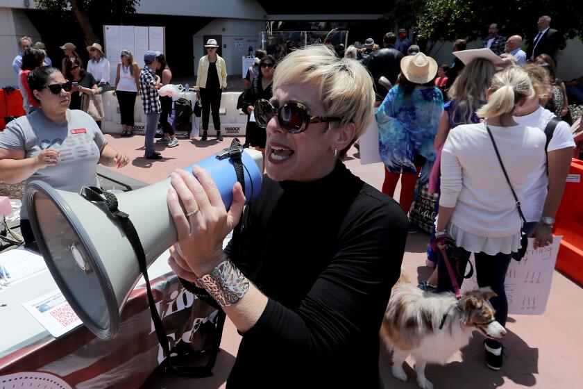 SANTA ANA, CA - MAY 11:. Protesters wait outside the county administration building to make public comments to the Orange County Board of Supervisors on Tuesday, May 11, 2021. Most commenters opposed the use of digital vaccine records, or "vaccine passports," to document a person's COVID-19 vaccination status. (Luis Sinco / Los Angeles Times)