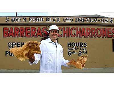 The edible side of Cesar E. Chavez Avenue. Mike Barreras, a fourth-generation chicharrón maker, shows off his wares.
