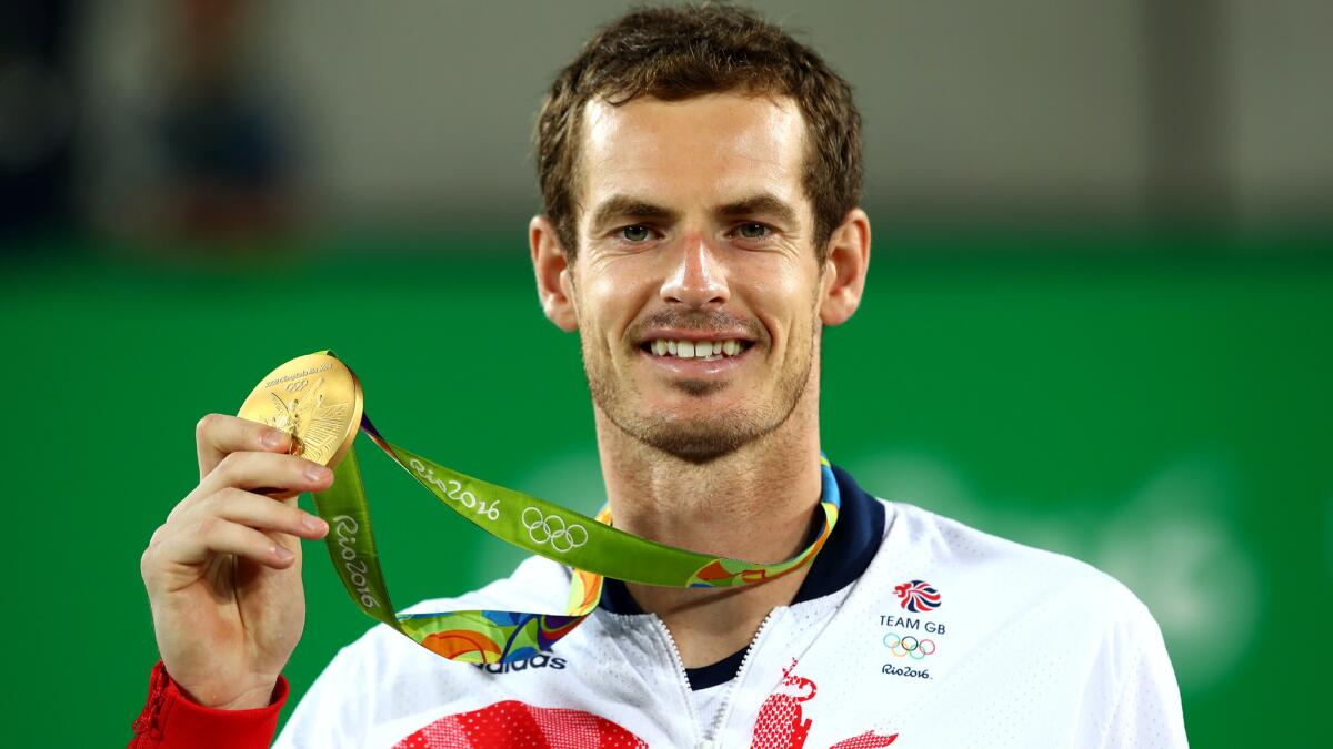 Britain's Andy Murray shows off his gold medal after defeating Juan Martin del Potro on Sunday.