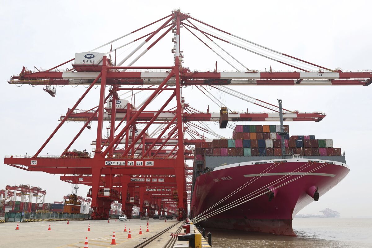 In this photo released by Xinhua News Agency, a container ship from Japan is anchored at the container dock of Shanghai's Yangshan Port in east China on April 27, 2022. China's export growth tumbled in April after Shanghai and other industrial cities were shut down to fight virus outbreaks. (Chen Jianli/Xinhua via AP)