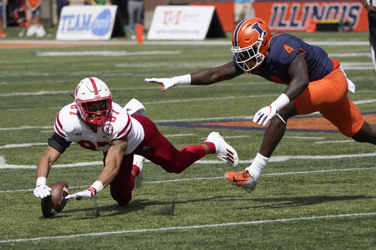 Nebraska wide receiver Chris Hickman is unable to catch a pass from quarterback Adrian Martinez as Illinois defensive back Derrick Smith defends during the second half of an NCAA college football game Saturday, Aug. 28, 2021, in Champaign , Ill. Illinois won 30-22. (AP Photo/Charles Rex Arbogast)