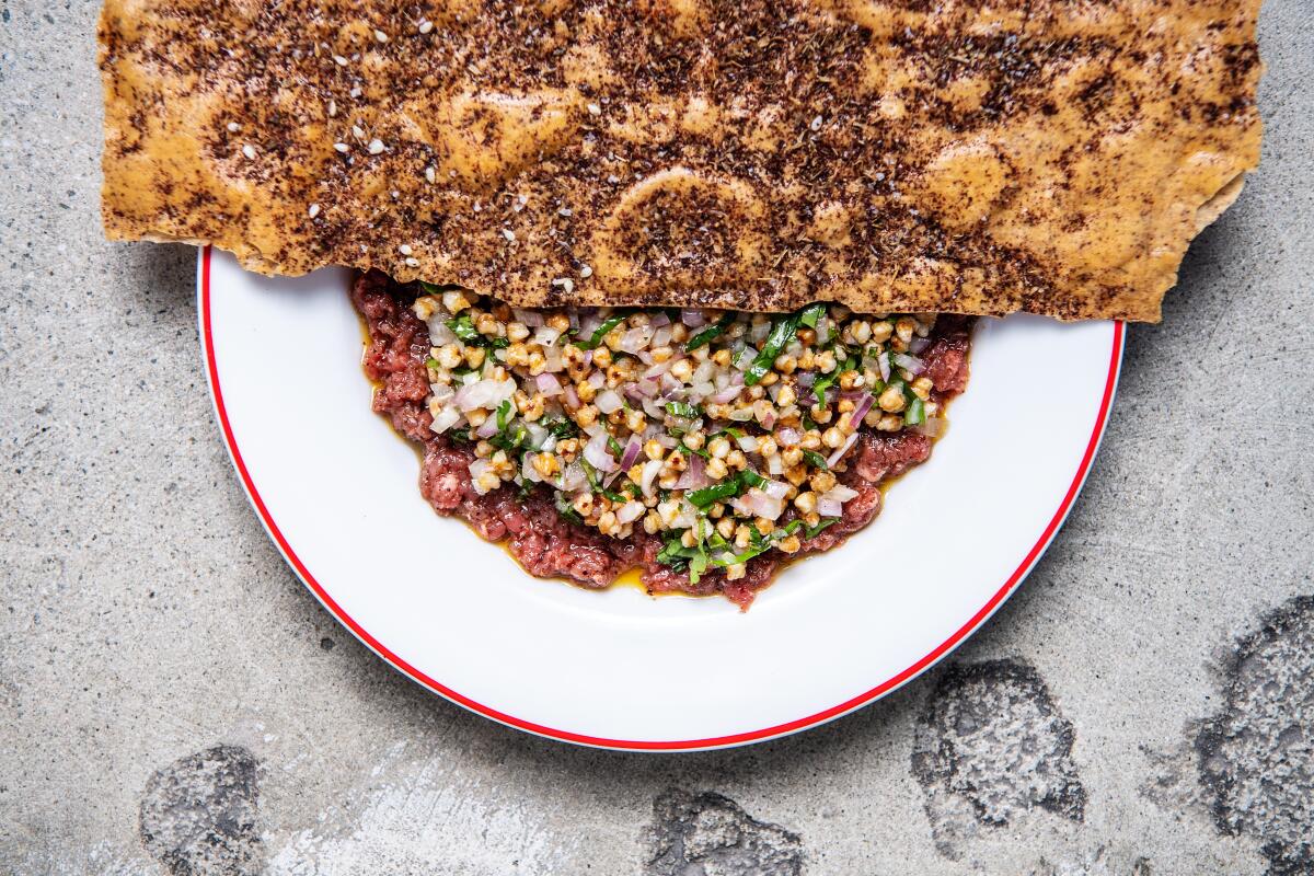 A layer of buckwheat covers the lamb tartare.