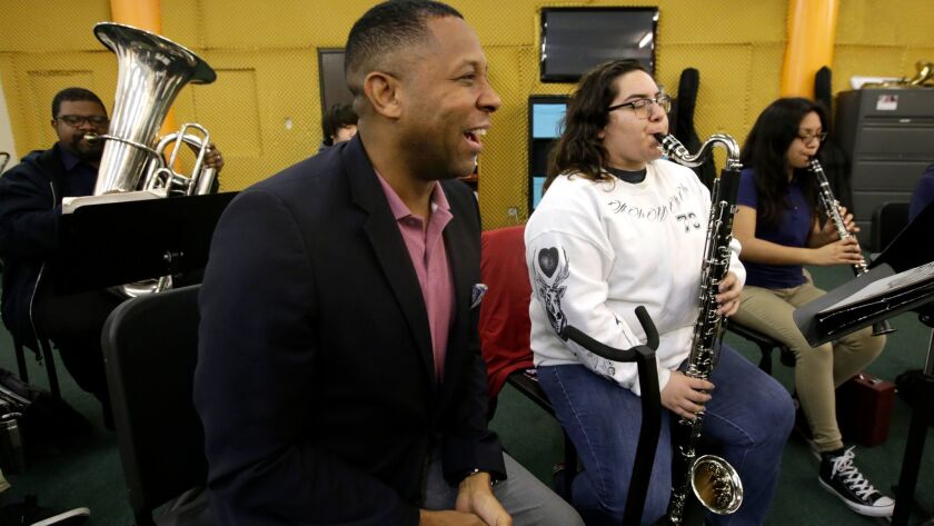 Tony Brown, the executive director of the nonprofit Heart of Los Angeles program, visits young orchestra students on the HOLA campus in Los Angeles.