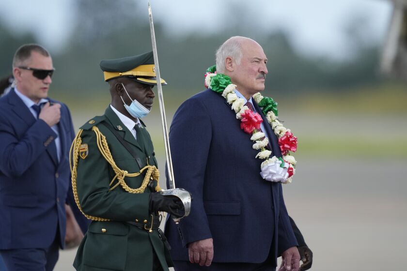 Belarus President Alexander Lukashenko, right, arrives at Robert Mugabe International airport in Harare, Monday, Jan, 30, 2023. (AP Photo/Tsvangirayi Mukwazhi)