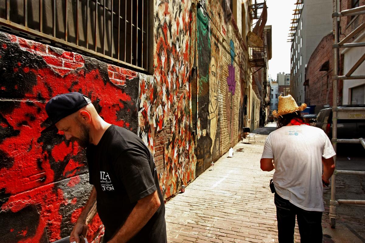 Photographer and artist Stephen Zeigler, left, and artist Wildlife stand inside the historic Indian Alley on Werdin Place in skid row in Los Angeles in 2013.