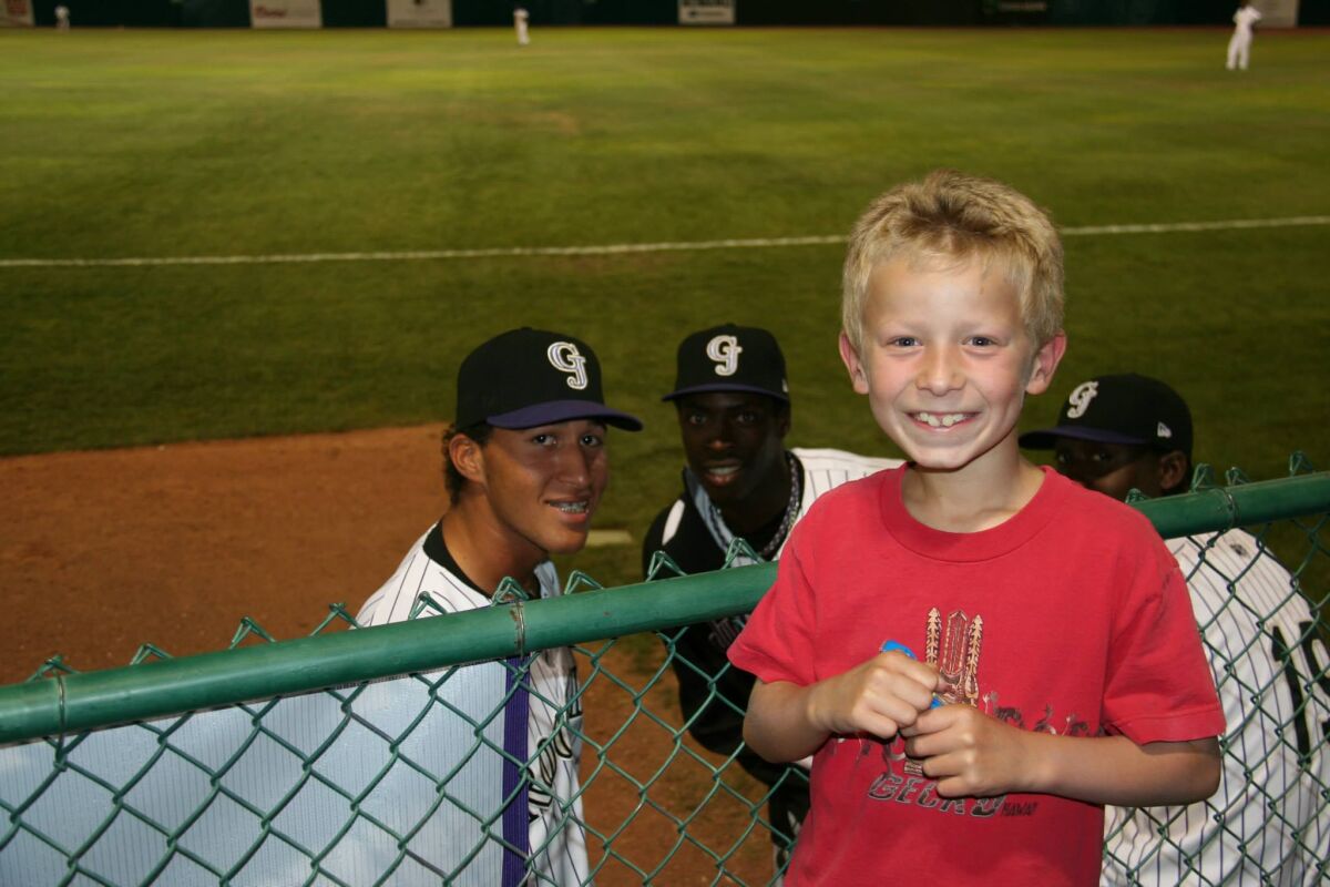 Carlos Estévez, left, smiles while posing with Josh Hays for a photo during a minor-league game.