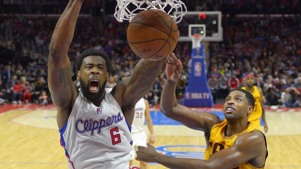 Clippers center DeAndre Jordan, left, dunks over Cleveland Cavaliers forward Tristan Thompson during the Clippers' 126-121 loss on Jan. 16.