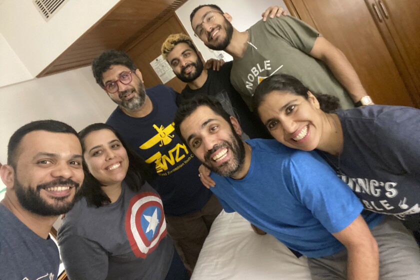 This photo from March 2020 shows participants, from left, Zubin Gheesta, Parinaz Navder, trip leader Arzan Sam Wadia, Sheherazad Pavri, Zruvan Chothia, Kayras Irani (bright blue shirt in the front), Mahfrin Santoke, in a group trip to Mumbai, India organized by Zoroastrian Return to Roots. The aim of the trip to help young Zoroastrians from other parts of the world learn more about the culture and history of their ancient faith. (Zoroastrian Return to Roots via AP)