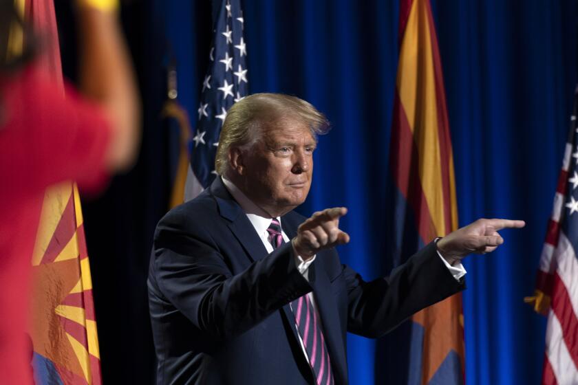 President Donald Trump points at the conclusion of a Latinos for Trump Coalition roundtable at Arizona Grand Resort & Spa, Monday, Sept. 14, 2020, in Phoenix. (AP Photo/Andrew Harnik)
