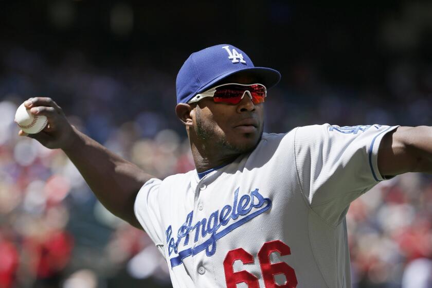 Dodgers' Yasiel Puig warms up prior to a game against Arizona on Sunday.