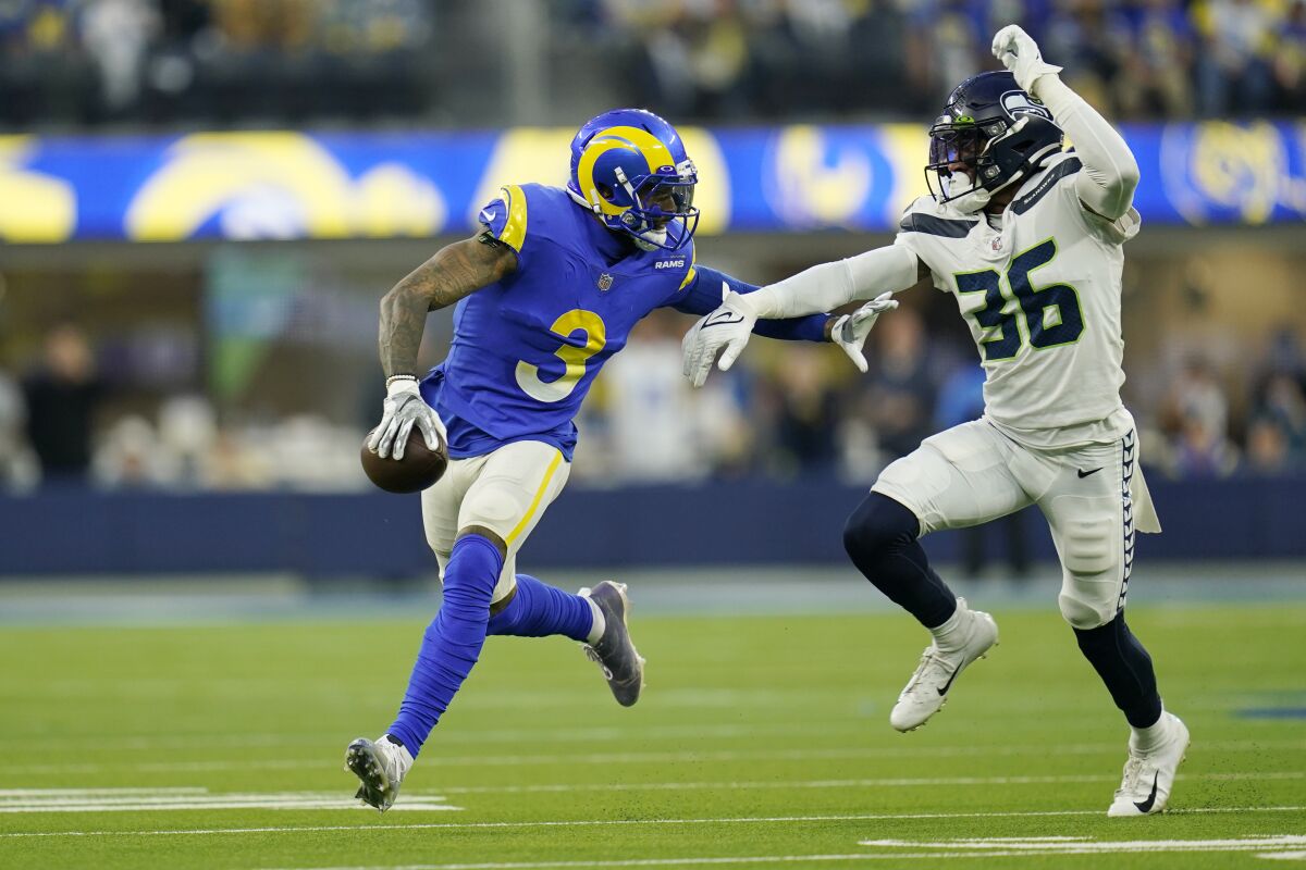 Rams wide receiver Odell Beckham Jr. is chased by Seattle Seahawks defensive back Bless Austin.