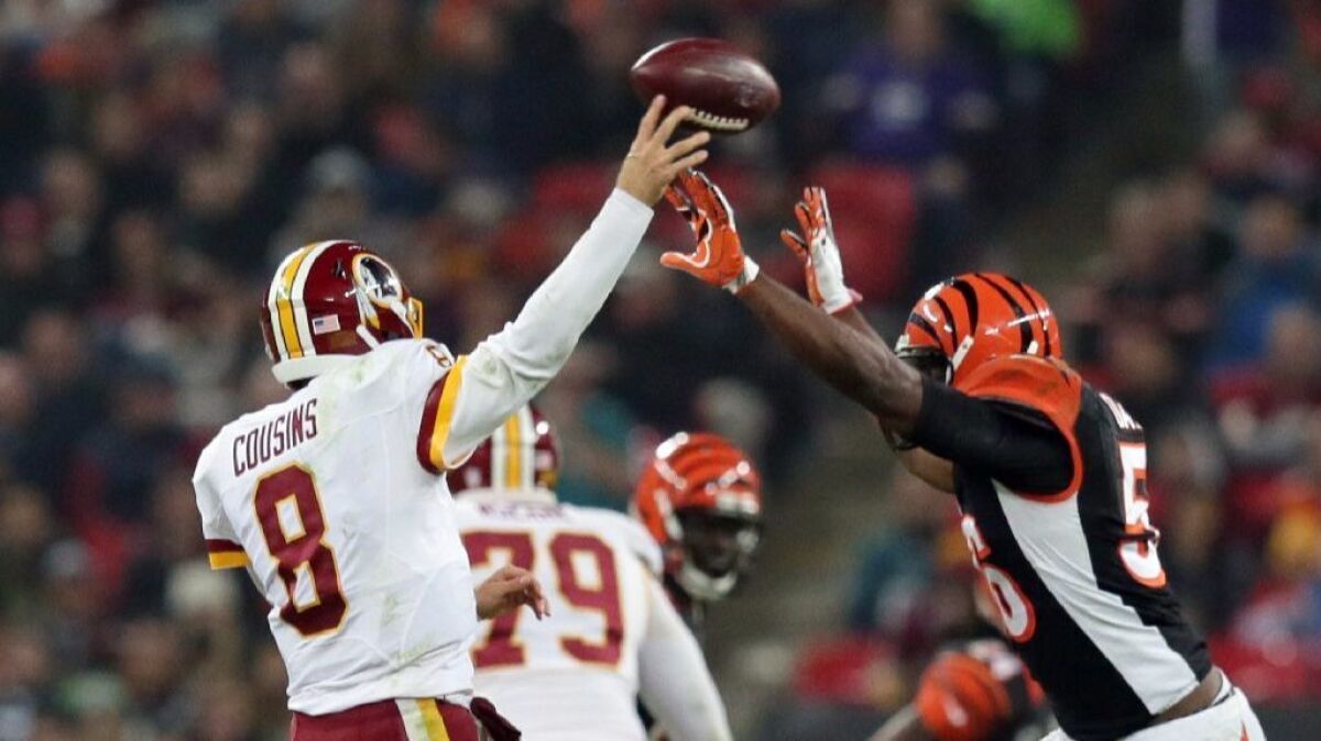 Bengals linebacker Karlos Dansby (56) tries to block the throw of Redskins quarterback Kirk Cousins during a game in London on Oct. 30.