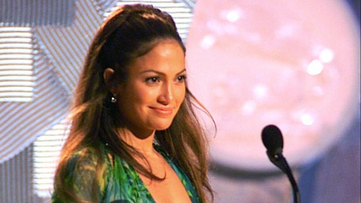 In this Feb. 23, 2000, file photo, Jennifer Lopez, wearing a sheer, low-cut silk chiffon Versace dress, appears on-stage to present an award during the 42nd Grammy Awards in Los Angeles.