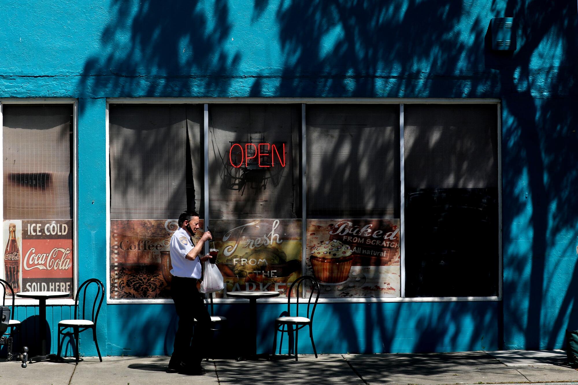 A customer leaves with a take-out order at Courthouse Cafe in Marysville.