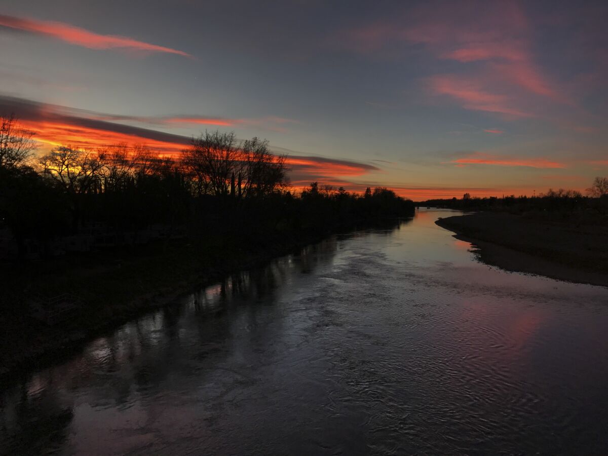 The predawn glow reflects in the Sacramento River in Red Bluff. 