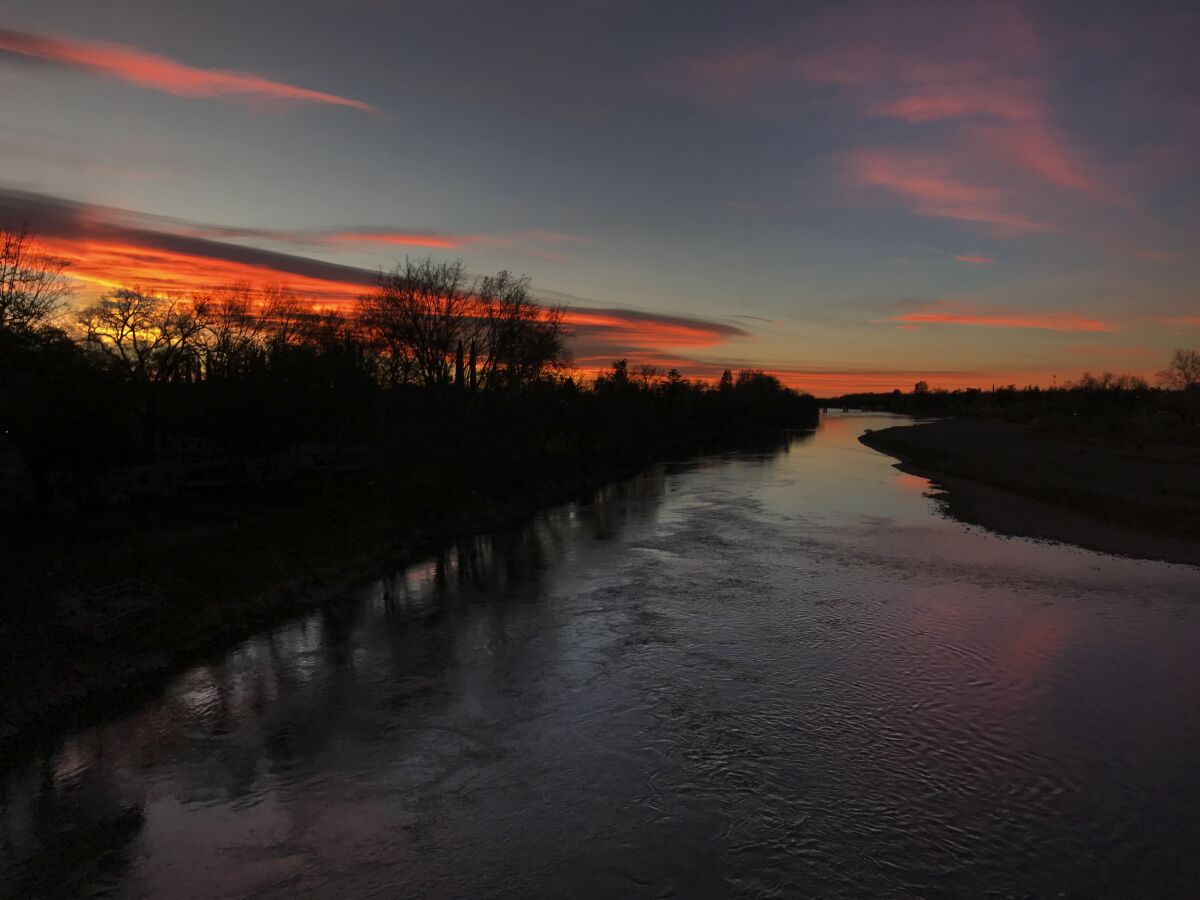 The predawn glow reflects in the Sacramento River in Red Bluff.