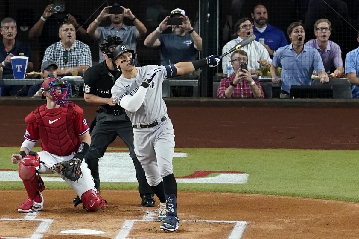 New York Yankees' Aaron Judge follows through on a solo home run, his 62nd of the season