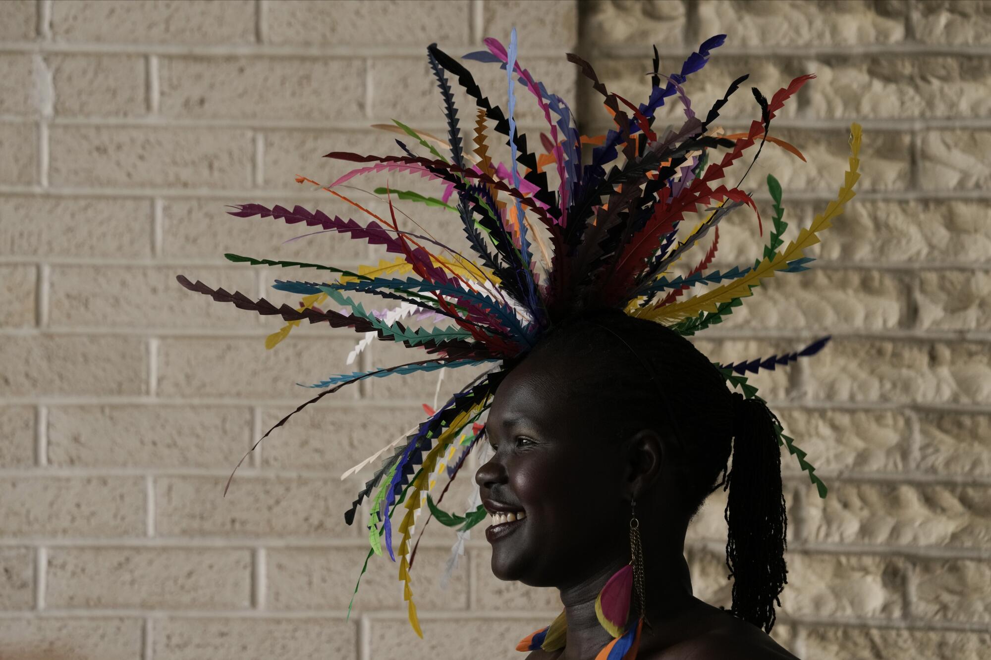 A race fan wears a hat with an elaborate swirl of multi-color ribbons on the grounds of Churchill Downs.