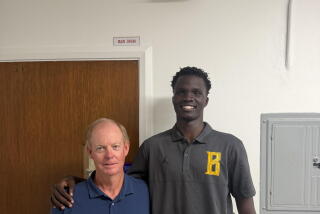 St. Bernard football coach Dean Herrington with his 6-foot-9 kicker Garang-Garang Macham from Sudan.