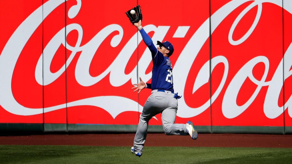 Dodgers center fielder Trayce Thompson catches a fly out by Angels' Mike Trout during an exhibition game on March 13.