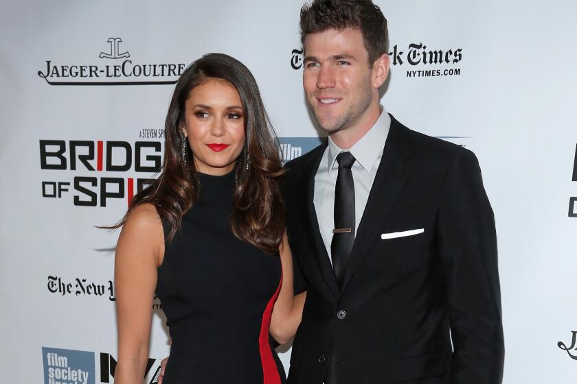 Nina Dobrev and Austin Stowell made their relationship red carpet official at the premiere of "Bridge of Spies" on Oct. 4, 2015, in New York.