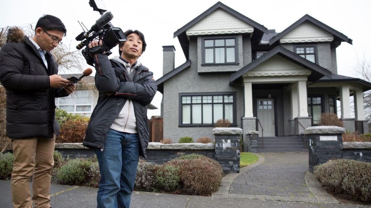 Members of the media wait outside the home of Huawei Technologies Chief Financial Officer Meng Wanzhou after she was released on bail in Vancouver, British Columbia in December.
