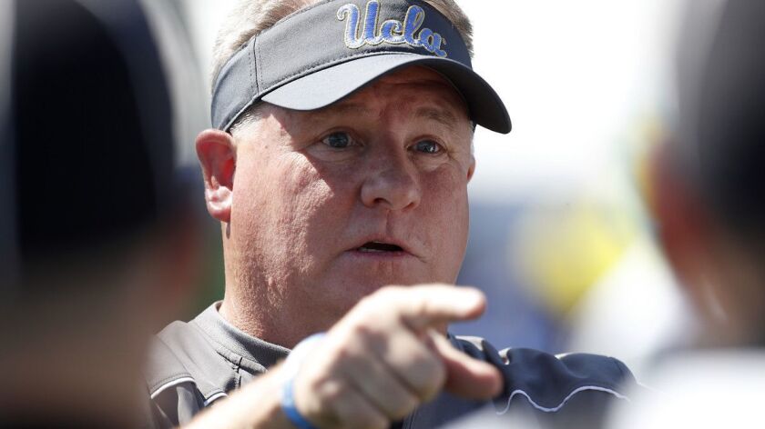UCLA head coach Chip Kelly talks with officials before the start of the UCLA spring football game at Drake Stadium on April 21.