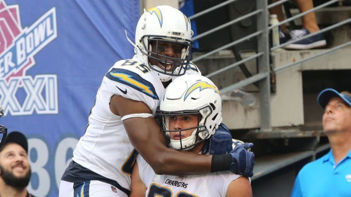 Chargers tight ends Antonio Gates, left, and Hunter Henry celebrate during a victory over the New York Giants in October. Gates is currently an unrestricted free agent and Henry is out for the season with a knee tear.