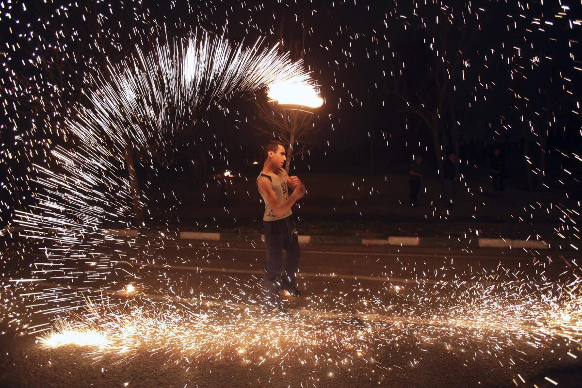 An Iranian man with fireworks in Tehran's Pardisan Park on Tuesday, during Chaharshanbe Suri, an ancient Festival of Fire.