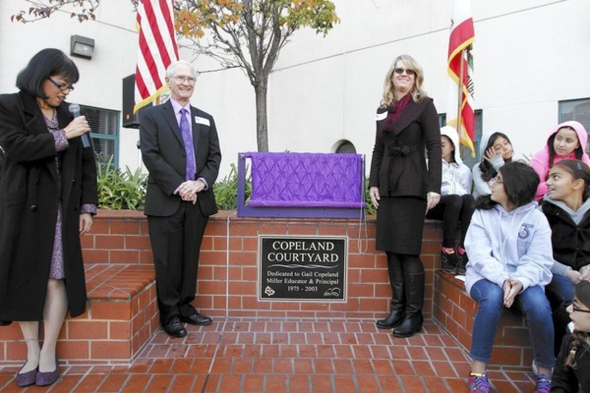 Joaquin Miller Elementary School principal Judy Hession, left, speaks as a plaque honoring former principal Gail Copeland is unveiled by her daughter Chris Copeland, right, and her widower Doug Copeland at the Burbank school on Friday, Dec. 13, 2013. Gail Copeland died earlier this year.