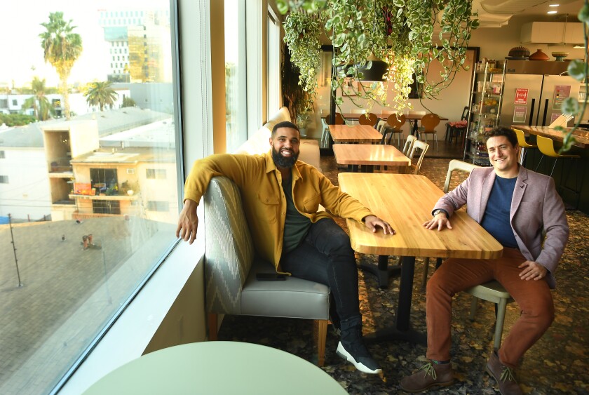 Prophet Walker, left, and Joe Green in a communal space at Treehouse. Every Sunday, residents gather here for a shared meal.