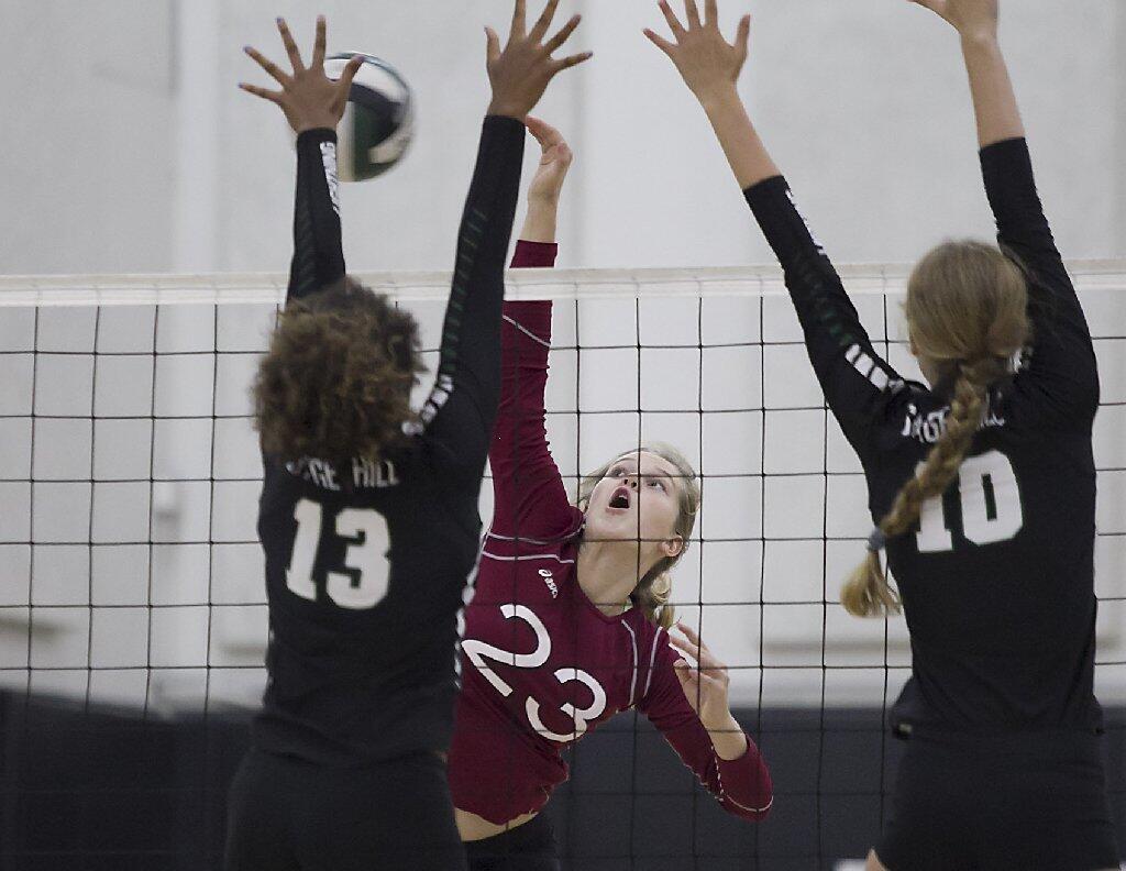 Laguna Beach High's Soren Patchell hits across the block of Sage Hill's Amiyah DeLong for a point.