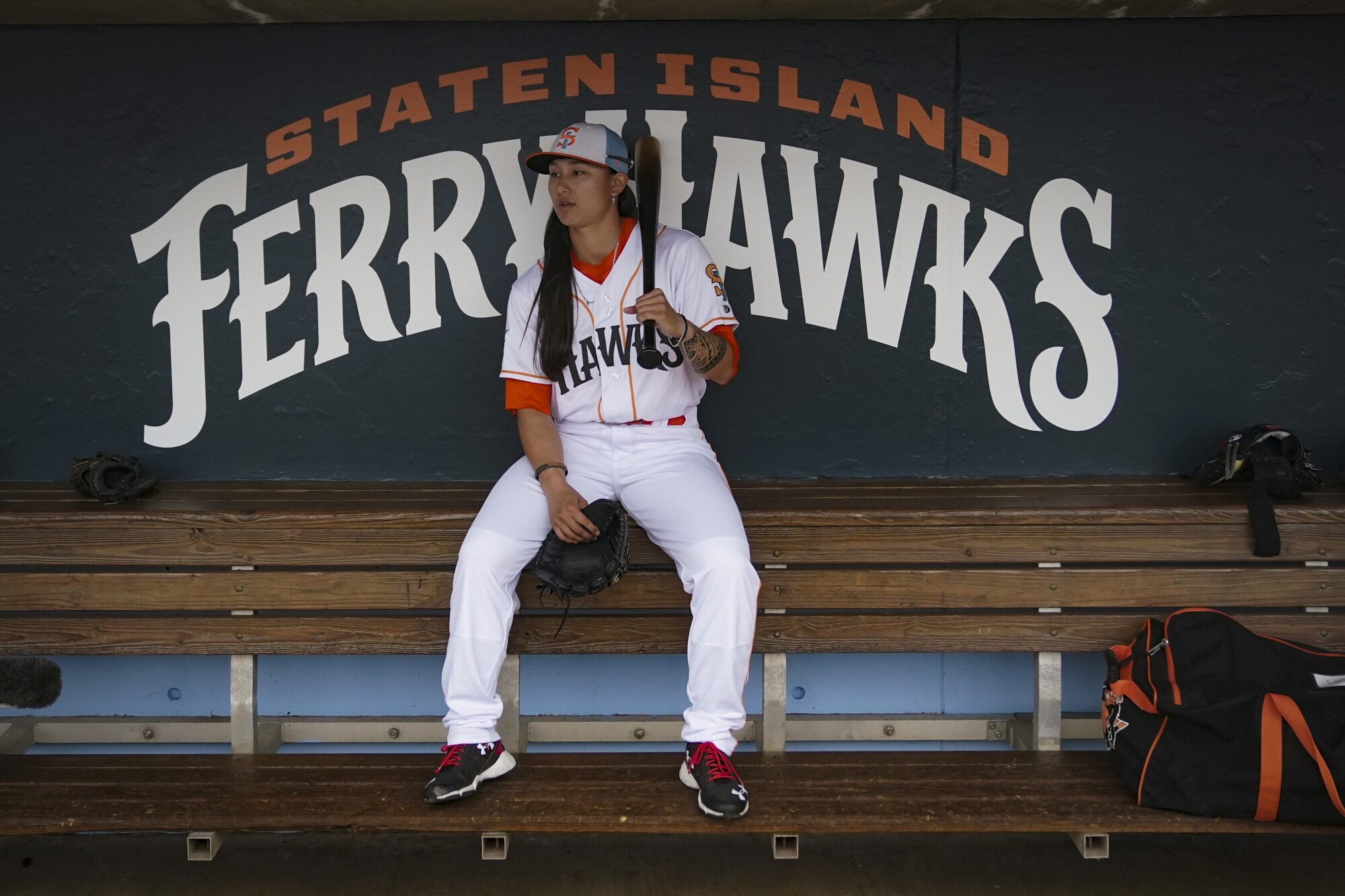 Kelsie Whitmore, a two-way player for the Atlantic League's Staten Island FerryHawks, sits in her team's dugout