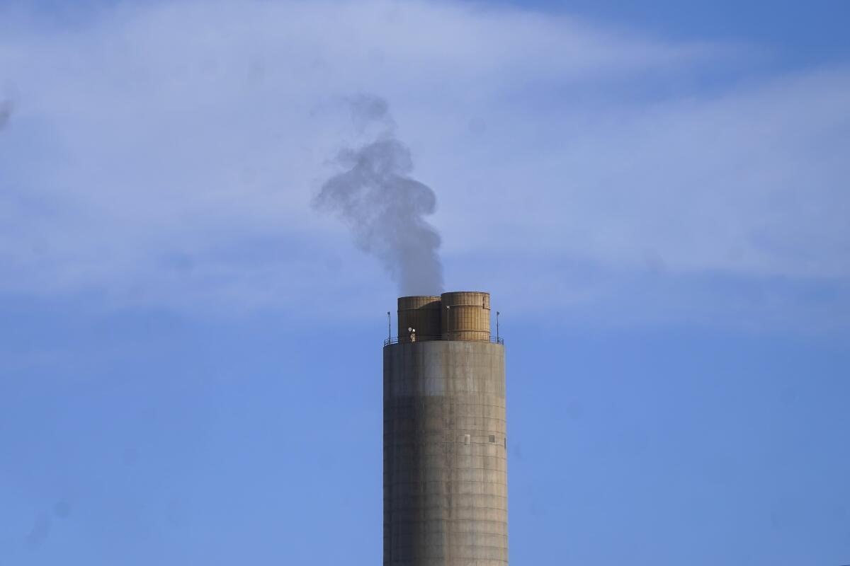 Smoke rises from a smokestack.