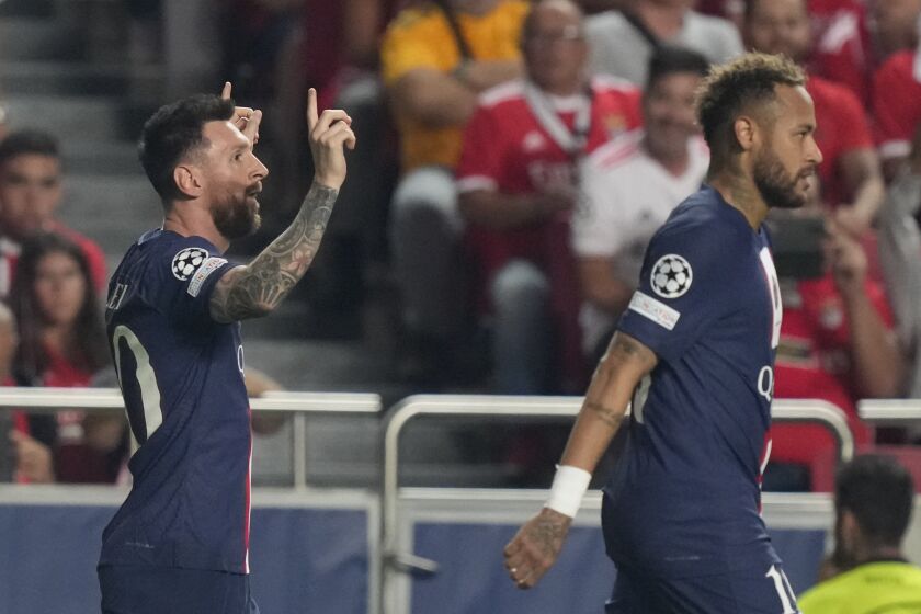 PSG's Lionel Messi, left, celebrates after scoring during the Champions League group H soccer match between SL Benfica and Paris Saint-Germain at the Luz stadium in Lisbon, Wednesday, Oct. 5, 2022. (AP Photo/Armando Franca)