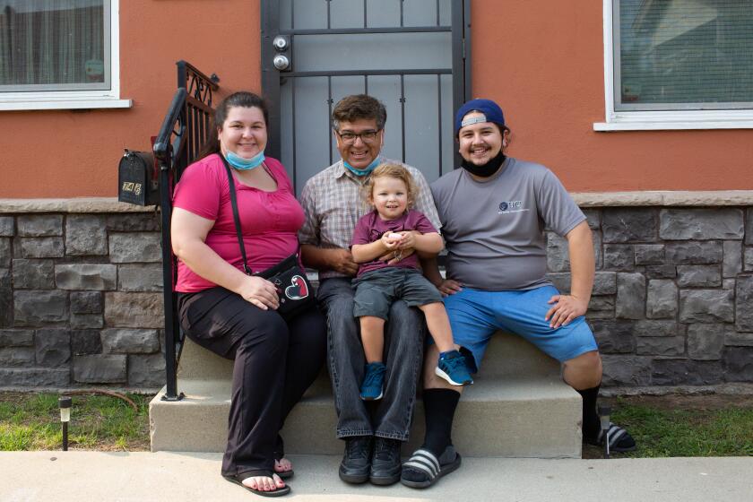 TORRANCE, CA - SEPTEMBER 14: From left: Athena Mata, Abel Mata, Milo Walker and Justin Walker pose for a portrait on Grandpa Abel's front porch on Monday, Sept. 14, 2020 in Torrance, CA. Police vehicles surrounded Abel Mata outside his Torrance home after a neighbor called 911 to report that a Latino man had abducted a white baby. Milo, the white 2-year-old, is Mata's grandson. When police responded, Mata claims they treated the woman who called 911 with more respect than him, even though she was holding a samurai sword and he had done nothing wrong. (Gabriella Angotti-Jones / Los Angeles Times)