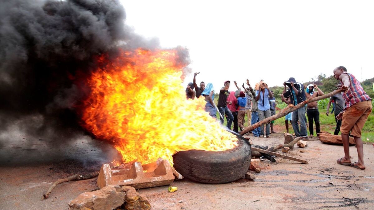 Protesters burn tires during a protest over the dramatic fuel price increases in Zimbabwe.