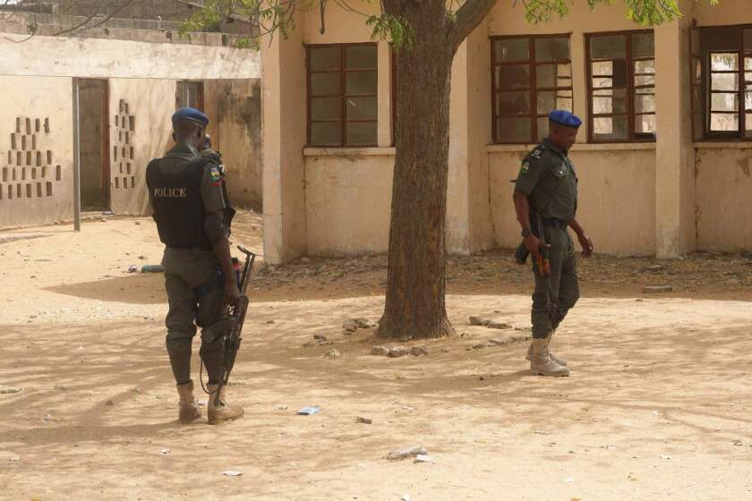 (FILES) In this file photo taken on February 28, 2018 policemen stand on guard at the premises of Government Girls Technical College, where 110 girls were kidnapped by Boko Haram Islamists at Dapchi town in northern Nigerian. Nigeria's government on March 1 said it had set up a committee to establish how Boko Haram jihadists managed to kidnap 110 girls from their school in the country's remote northeast. Members of the militant Islamist group stormed the Government Girls Science and Technical College in Dapchi, Yobe state, on February 19, nearly four years after a similar mass abduction in Chibok, Borno state. / AFP PHOTO / AMINU ABUBAKARAMINU ABUBAKAR/AFP/Getty Images ** OUTS - ELSENT, FPG, CM - OUTS * NM, PH, VA if sourced by CT, LA or MoD **