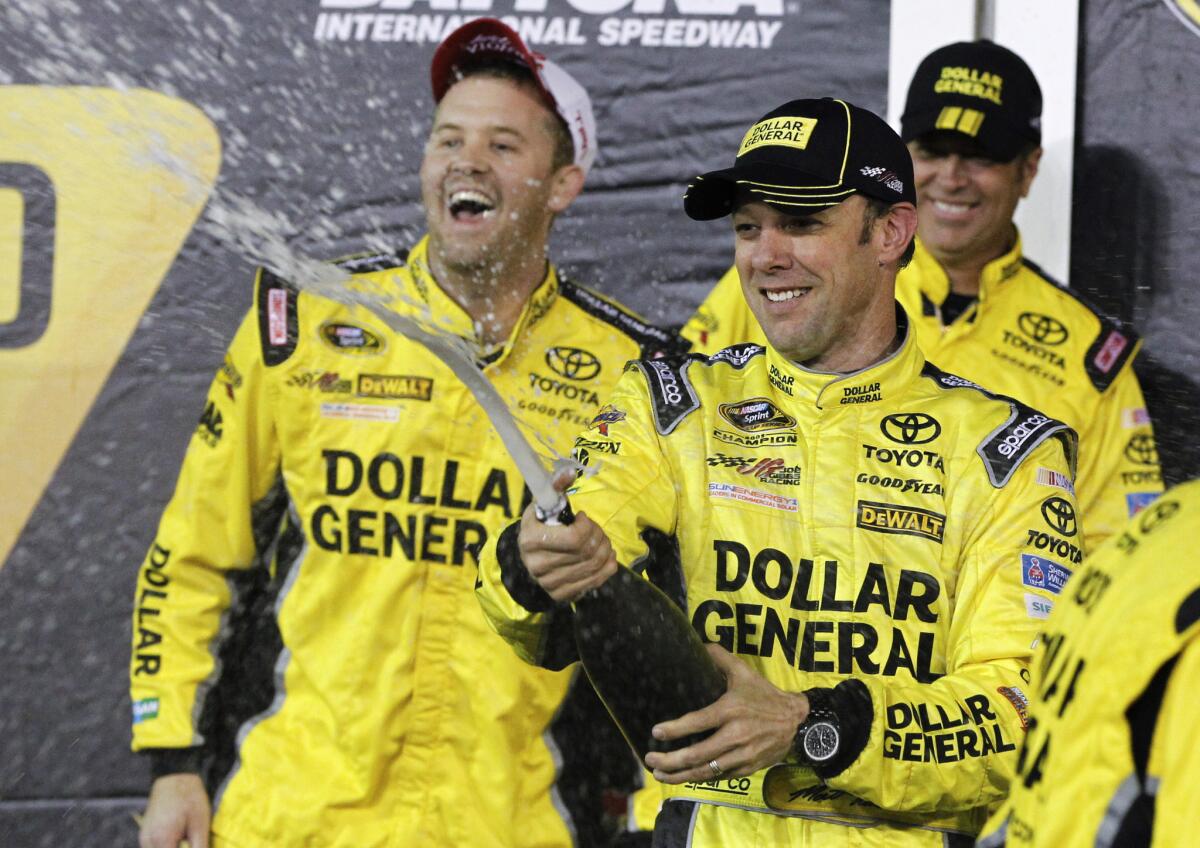 NASCAR driver Matt Kenseth celebrates with teammates after winning the Sprint Cup Unlimited race on Saturday night at Daytona International Speedway.