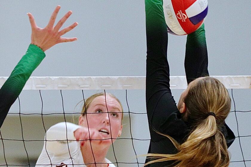 Palos Verdes senior Kelly Demaria powers a spike through a blocker.